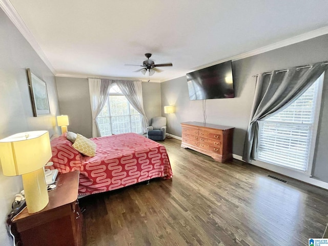 bedroom with ceiling fan, crown molding, and dark wood-type flooring