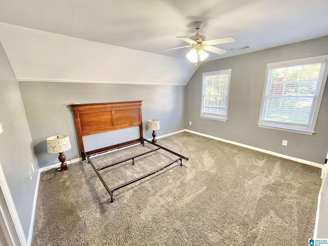 carpeted bedroom with vaulted ceiling and ceiling fan