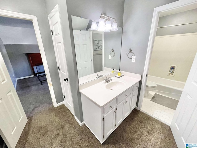 bathroom featuring vanity, toilet, and a notable chandelier