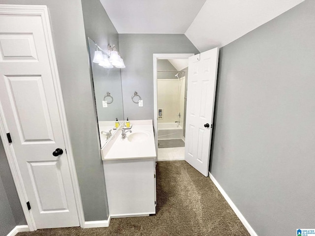 bathroom with vanity, shower / bath combination, and vaulted ceiling