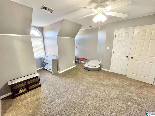 additional living space with carpet flooring and ceiling fan