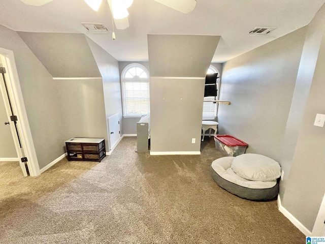 living area with carpet, ceiling fan, and lofted ceiling