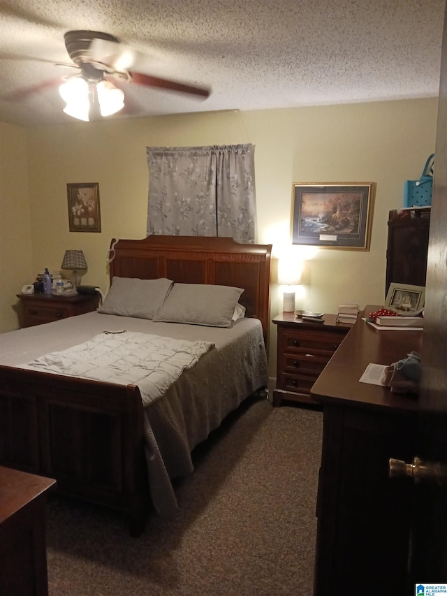 carpeted bedroom featuring ceiling fan and a textured ceiling