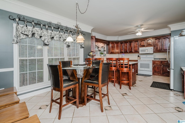 dining space featuring ceiling fan with notable chandelier, ornamental molding, and light tile patterned floors