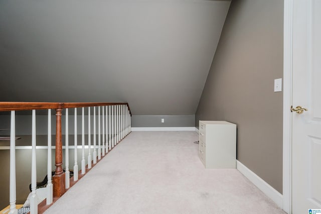 interior space with light colored carpet and lofted ceiling