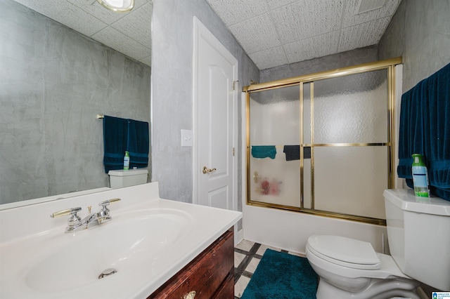 full bathroom with tile patterned floors, vanity, toilet, and shower / bath combination with glass door