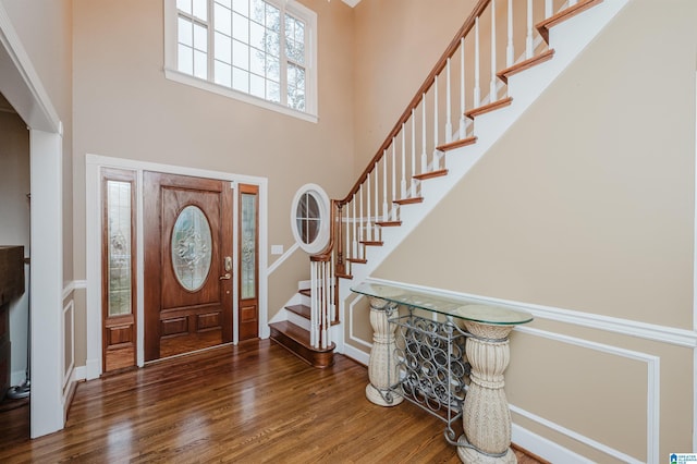 foyer with dark wood-type flooring and a high ceiling