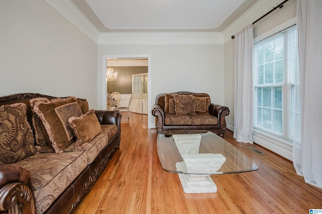 living room featuring light wood-type flooring and crown molding