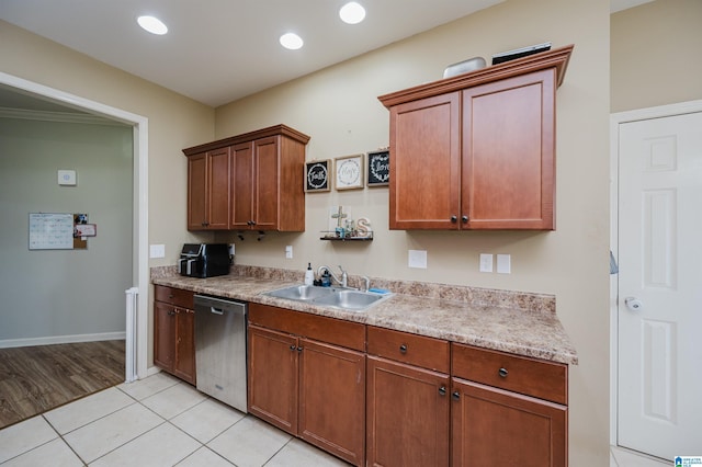 kitchen with dishwasher, light tile patterned floors, and sink