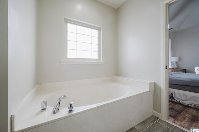 bathroom featuring hardwood / wood-style floors and a bath