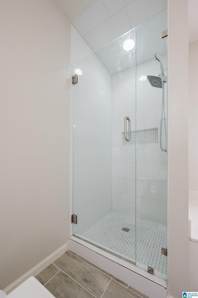 bathroom featuring tile patterned floors and a shower with door