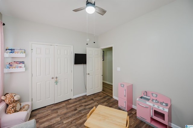 playroom featuring ceiling fan and dark wood-type flooring