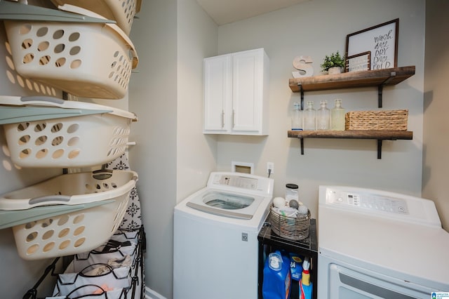 laundry room with washer and clothes dryer and cabinets