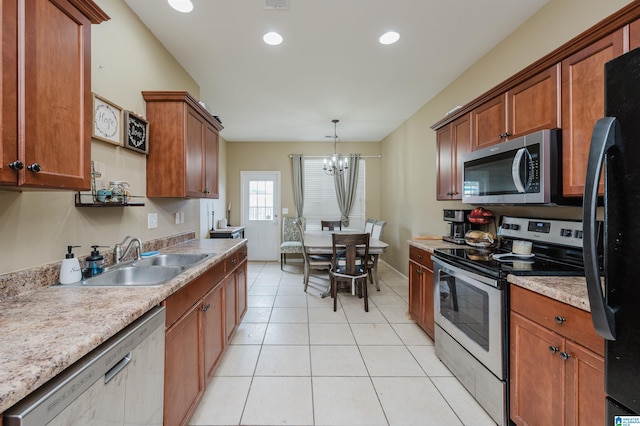 kitchen with stainless steel appliances, sink, pendant lighting, a chandelier, and light tile patterned flooring