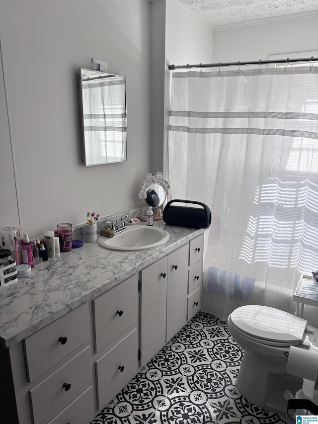 bathroom featuring a wealth of natural light, vanity, a textured ceiling, and toilet