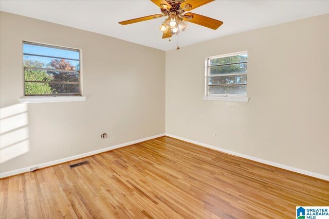 empty room with light hardwood / wood-style flooring and ceiling fan