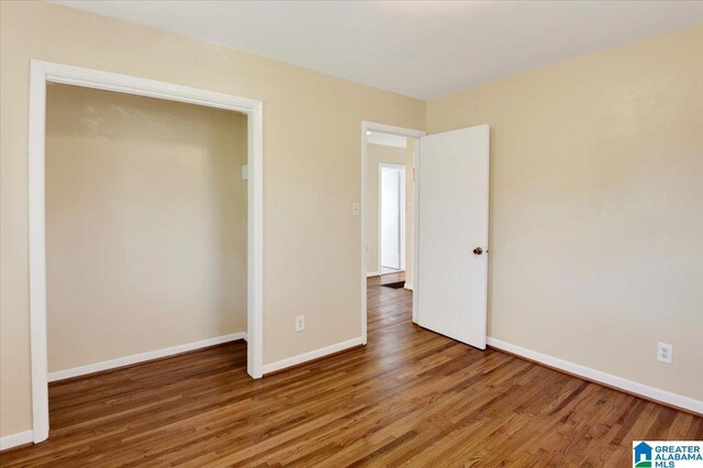 unfurnished bedroom featuring hardwood / wood-style flooring