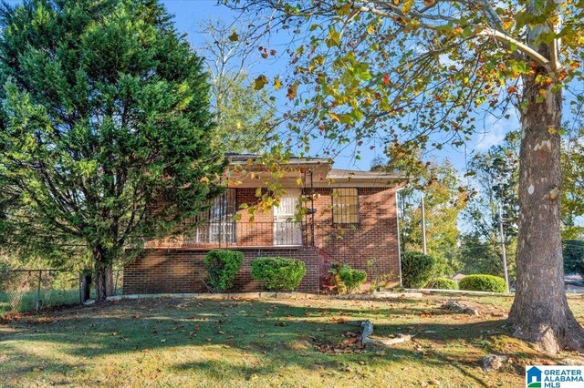 view of side of home with a lawn