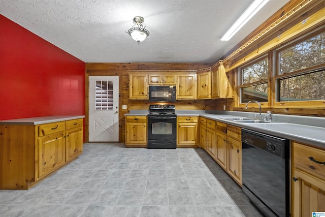 kitchen with a textured ceiling, sink, and black appliances