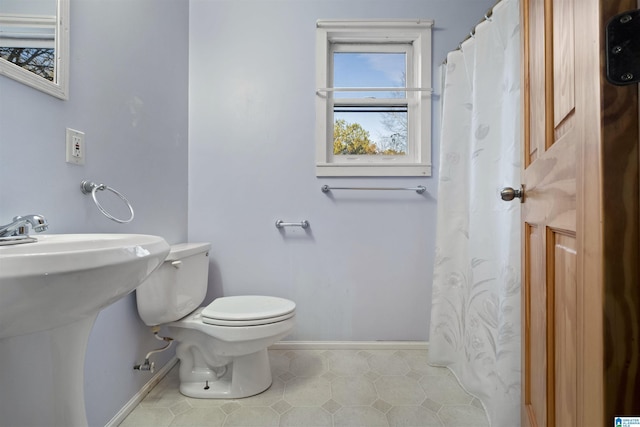 bathroom featuring tile patterned floors, sink, and toilet