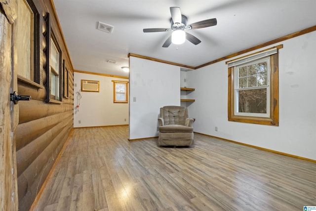 unfurnished room featuring ceiling fan, ornamental molding, an AC wall unit, and light hardwood / wood-style flooring