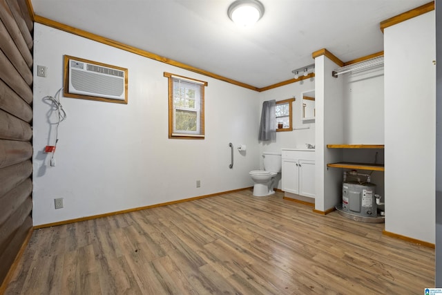 bathroom with hardwood / wood-style flooring, toilet, a wall mounted air conditioner, and ornamental molding