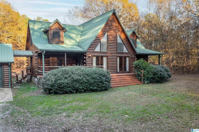 cabin with a front yard