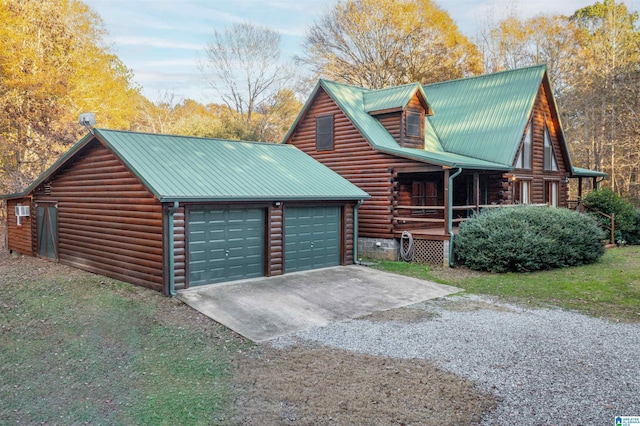 exterior space with an outbuilding, a porch, and a garage