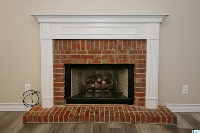 room details with a fireplace and hardwood / wood-style flooring