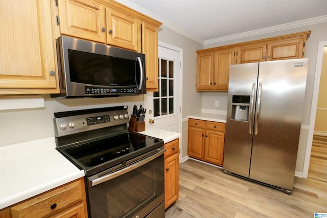 kitchen with a textured ceiling, crown molding, stainless steel appliances, and light hardwood / wood-style flooring