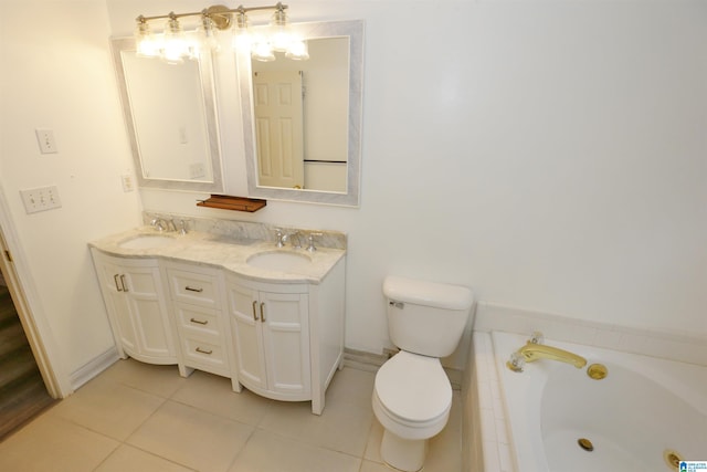 bathroom featuring tile patterned floors, a bathing tub, vanity, and toilet