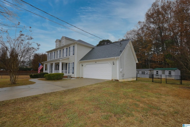 view of front of house with a front lawn, covered porch, and a garage