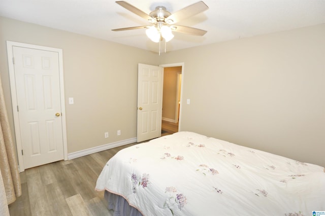 bedroom with ceiling fan and light hardwood / wood-style floors