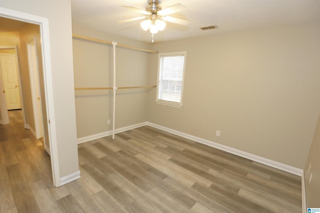 spare room with hardwood / wood-style flooring and ceiling fan