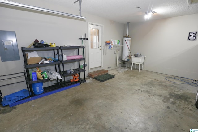 garage featuring gas water heater, sink, and electric panel