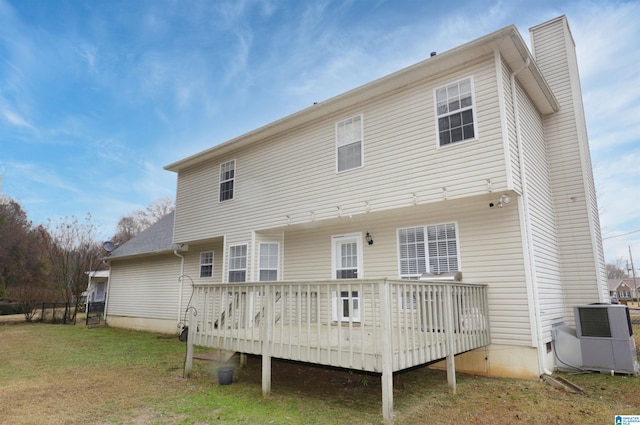 rear view of house with a yard and a wooden deck