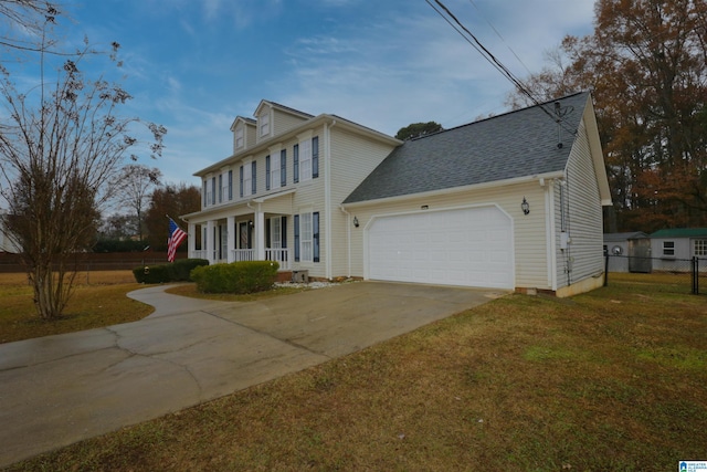 colonial inspired home with a front lawn, covered porch, and a garage