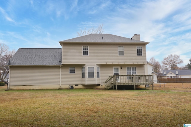 back of property with a lawn and a deck