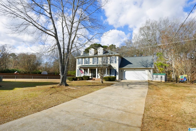 colonial inspired home featuring a front yard, a porch, and a garage