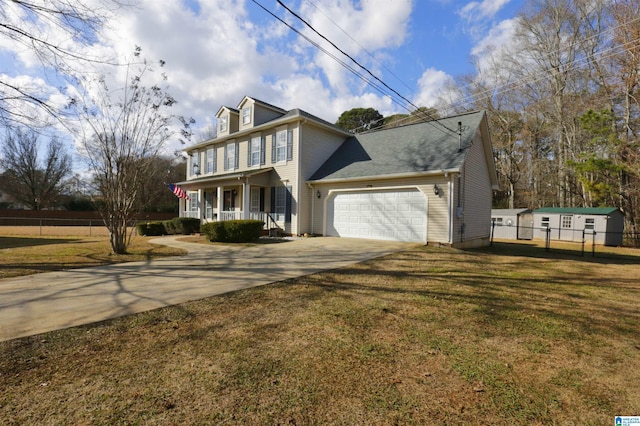 view of front of home featuring covered porch, a garage, and a front lawn