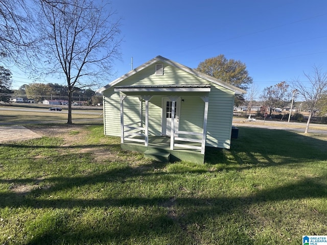 view of outbuilding with a yard