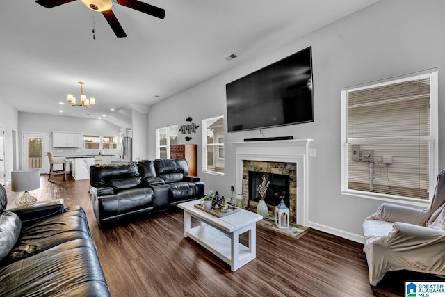 living room with a fireplace, dark wood-type flooring, and vaulted ceiling