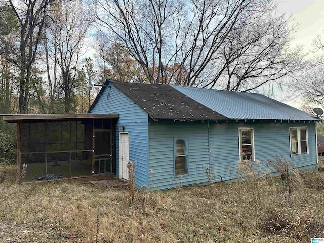 view of home's exterior with a sunroom