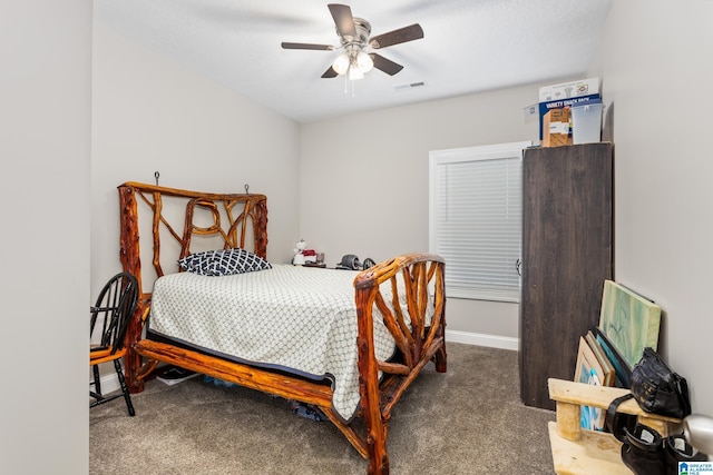 bedroom featuring dark colored carpet and ceiling fan