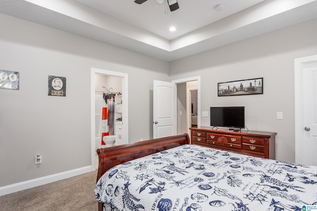 carpeted bedroom featuring ensuite bath and ceiling fan