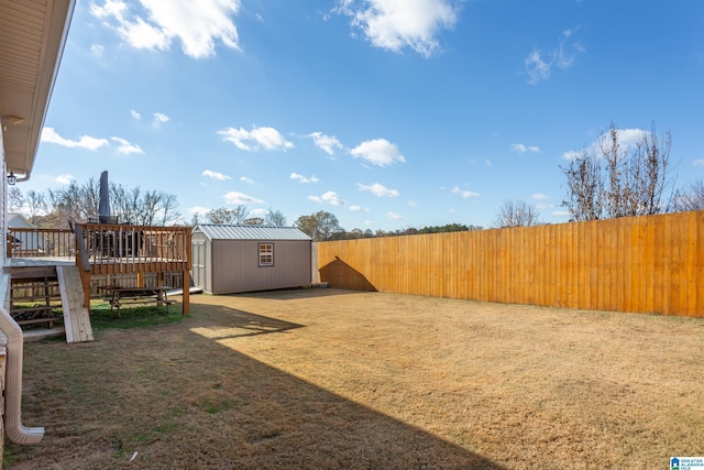 view of yard featuring a storage shed and a wooden deck