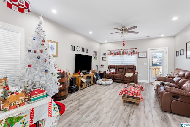 living room with ceiling fan and light hardwood / wood-style floors