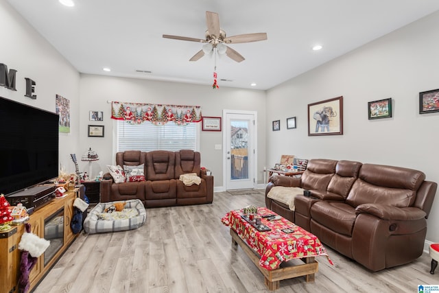 living room with ceiling fan and light hardwood / wood-style floors