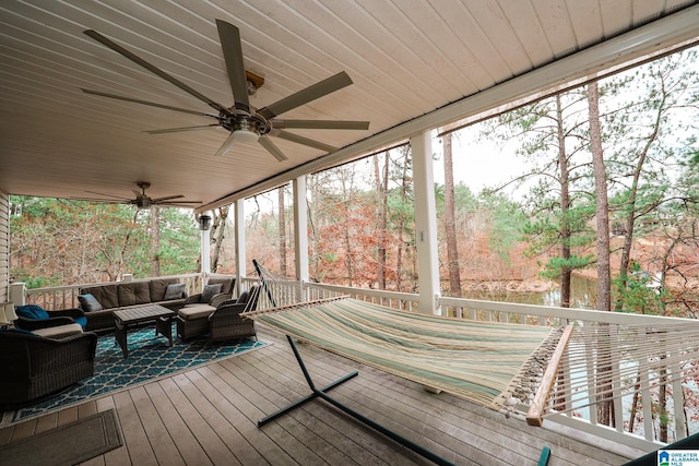 wooden deck with ceiling fan and an outdoor hangout area