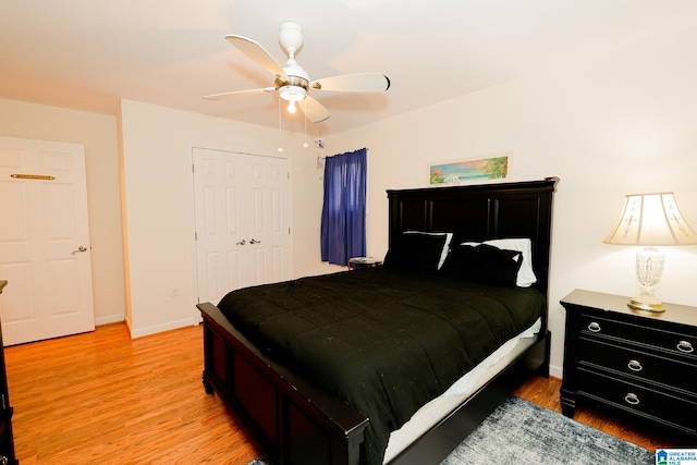 bedroom with ceiling fan, a closet, and light wood-type flooring